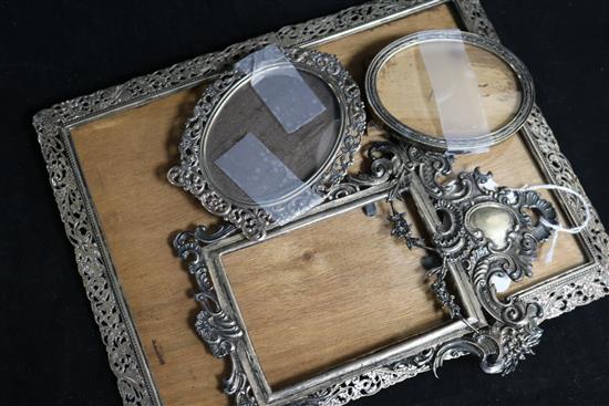 Four Continental white metal photograph frames, variously pierced and embossed